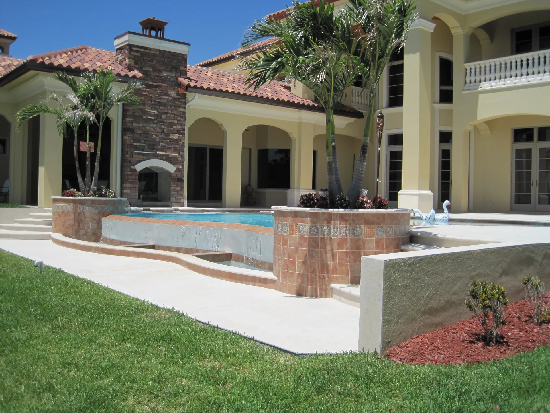 Elevated pool with spillover walls