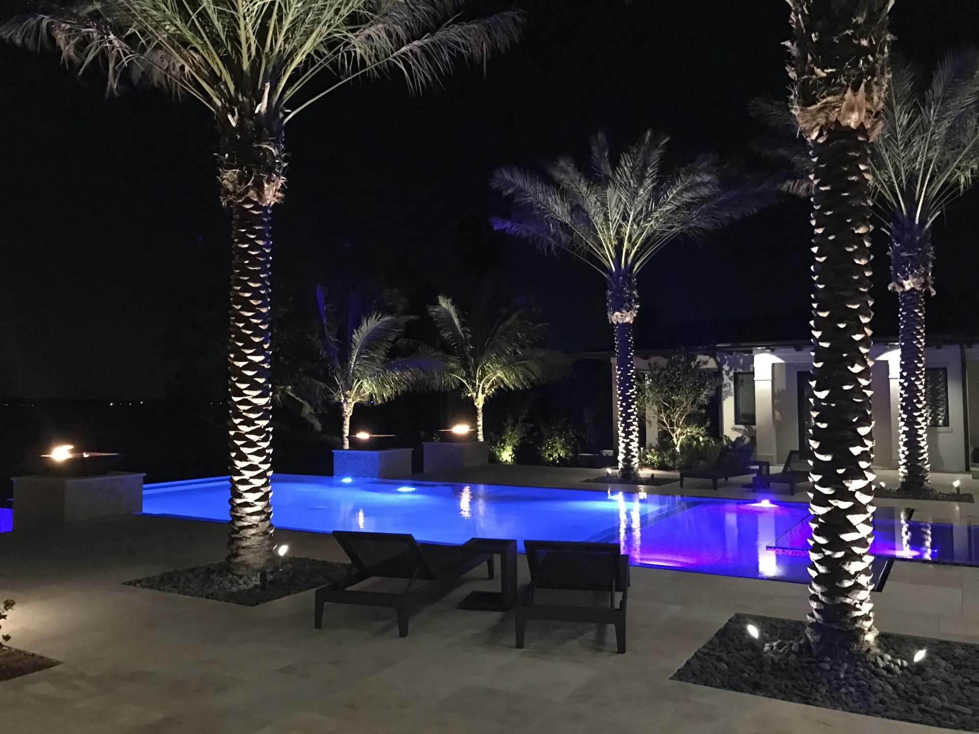 Large geometric pool glowing blue from LED lighting at night