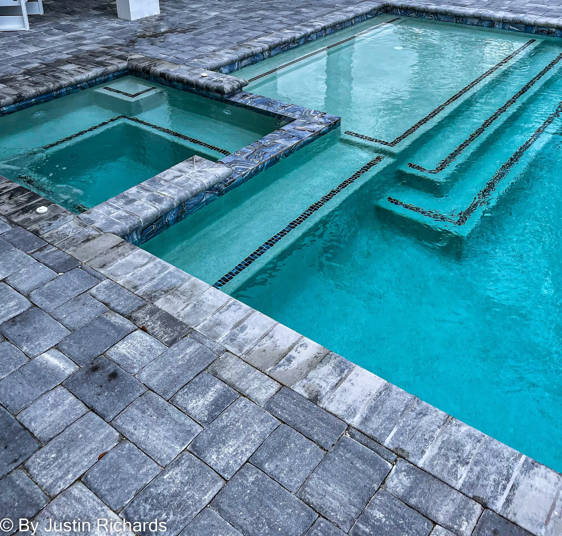 Square spa with blue glass-tile walls