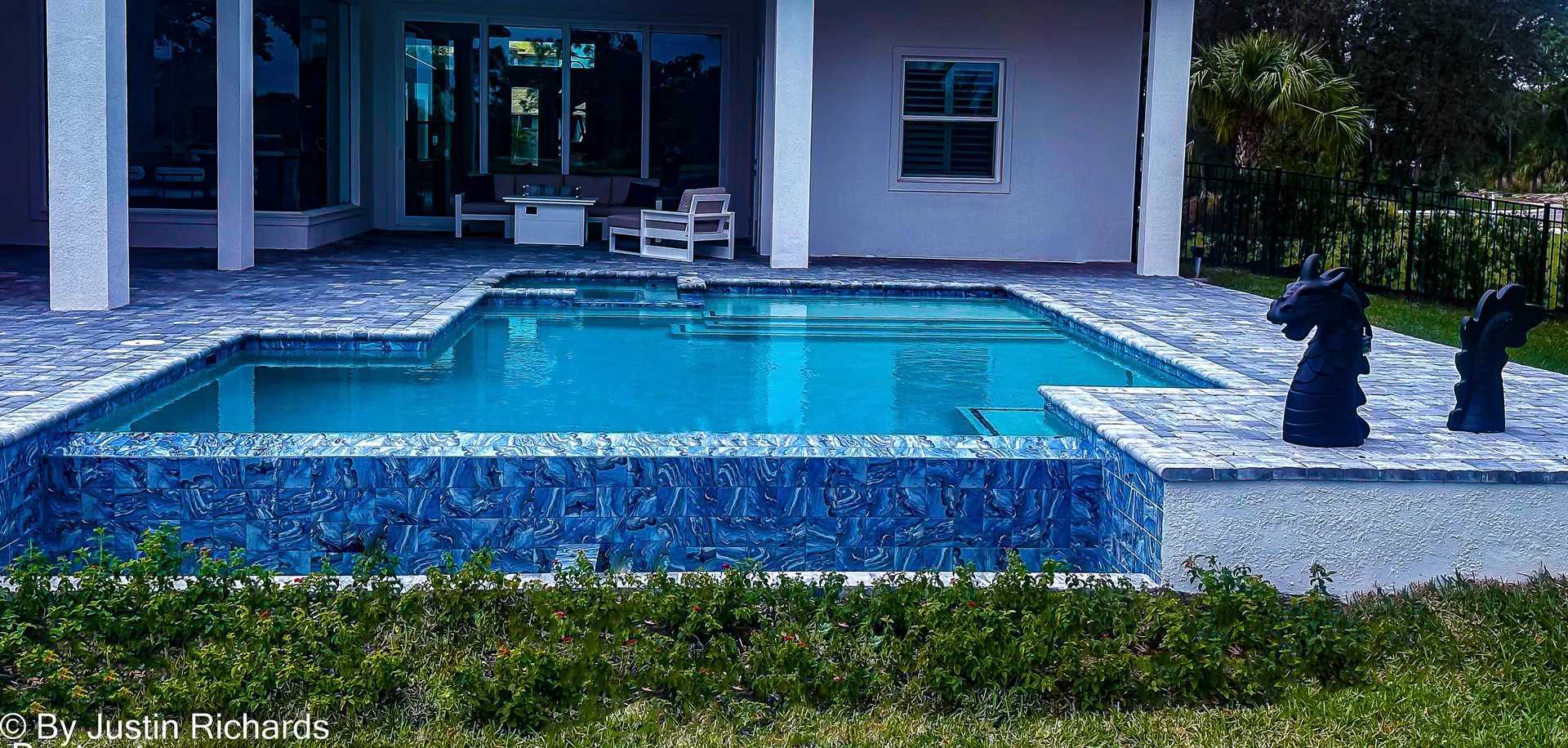 Raised glass-tile spa wall