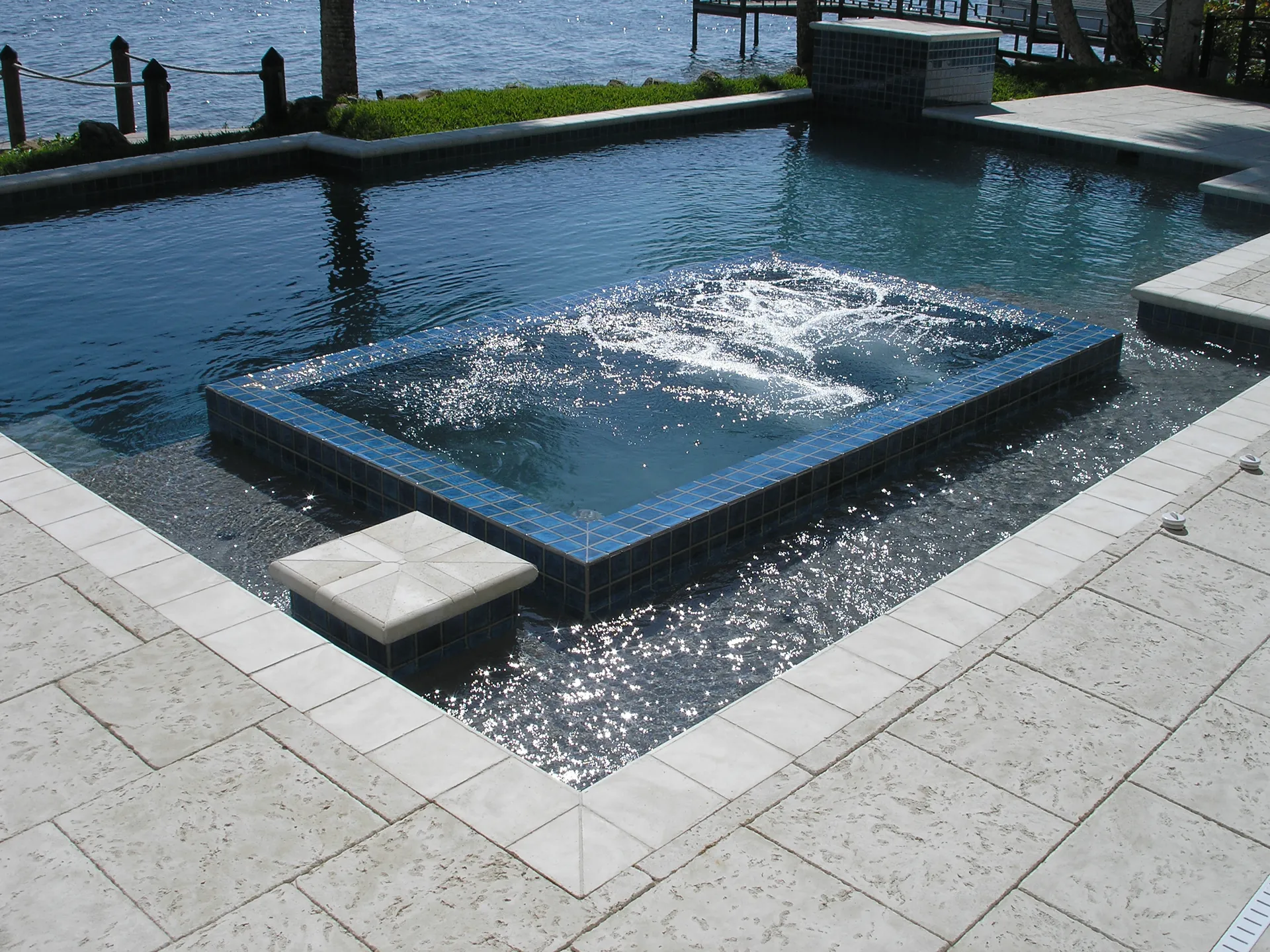 Raised blue-tile spa with fountain jet