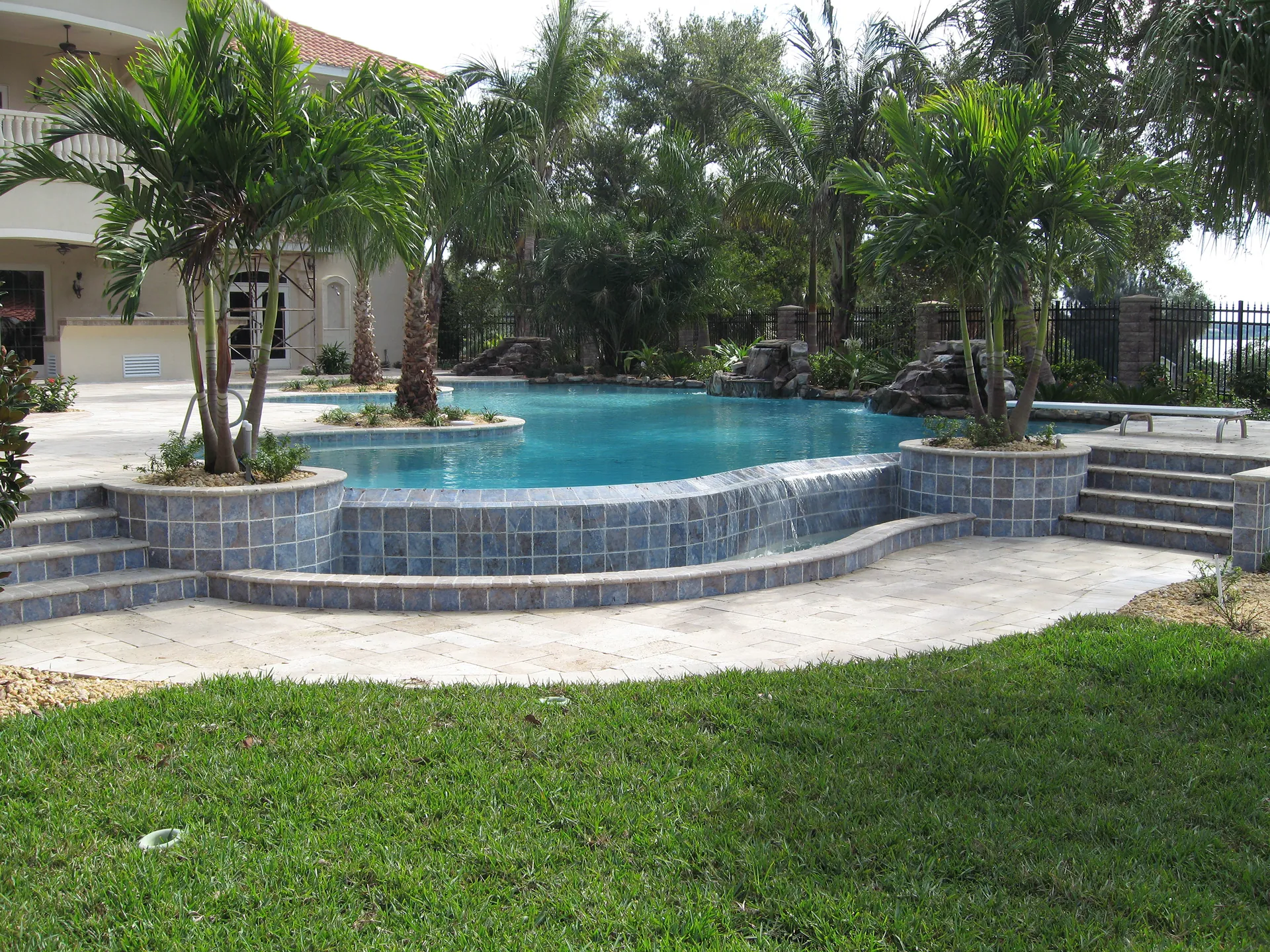 Raised blue-tile spa with sheet waterfall